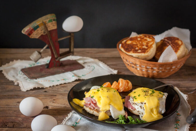 Eggs benedict with parsley and orange garnish