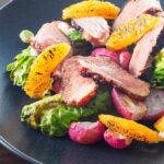 Duck breast salad with oranges, readishes, and asparagus.
