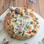 Lobster pizza on wooden pizza peel.