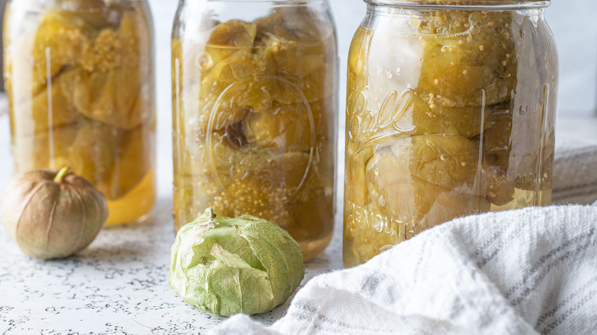 Three quart jars of tomatillos.