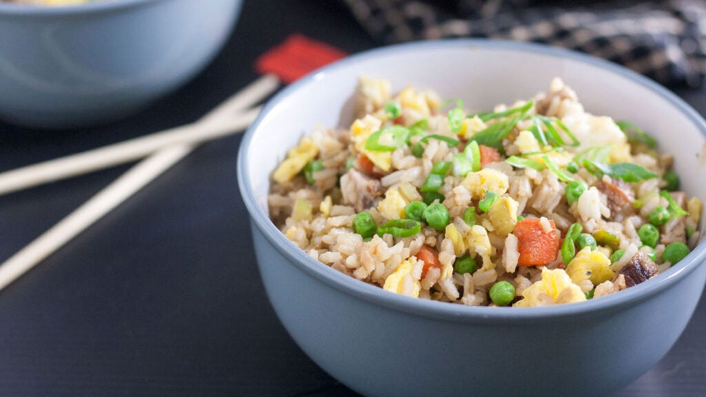 Bowls of fried rice with chopsticks.