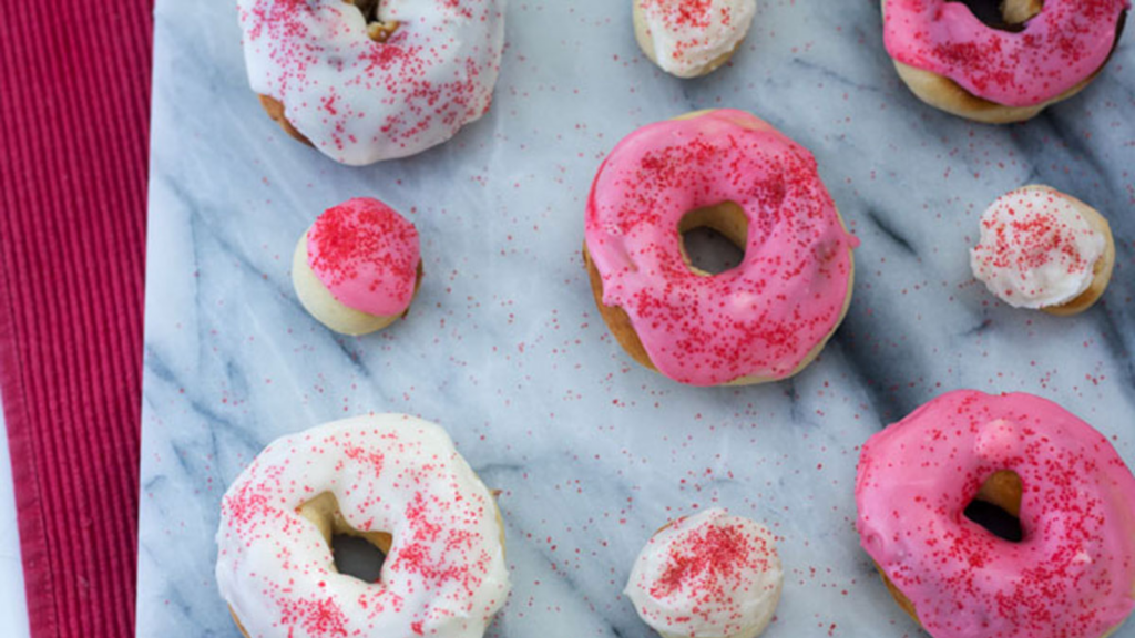 Pink doughnuts with sprinkles.
