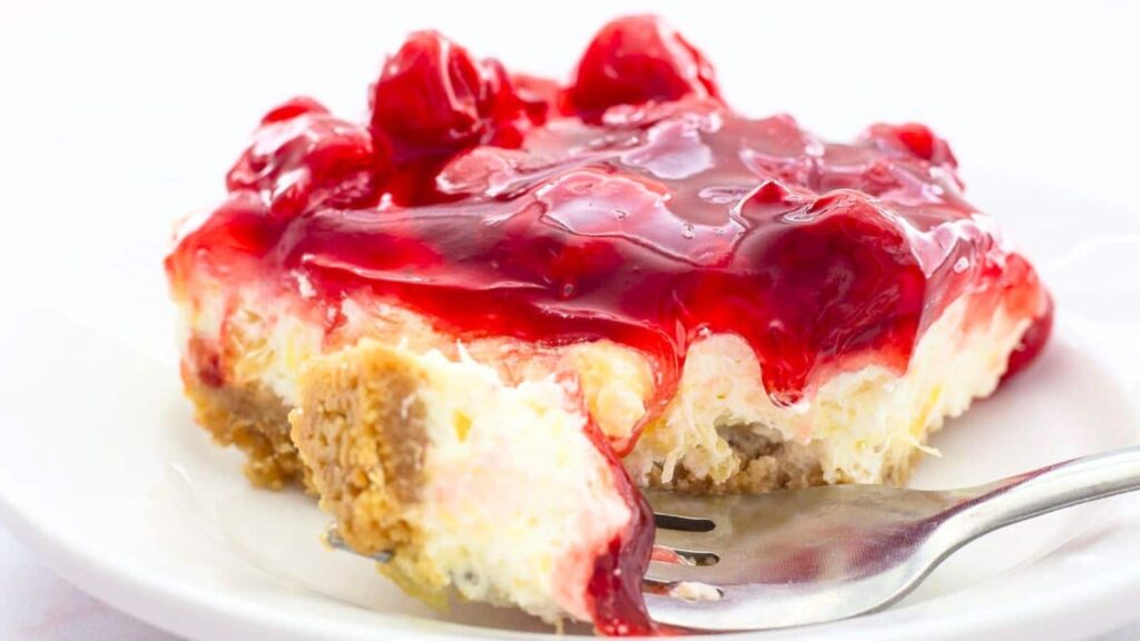 A slice of cherry delight on a plate.