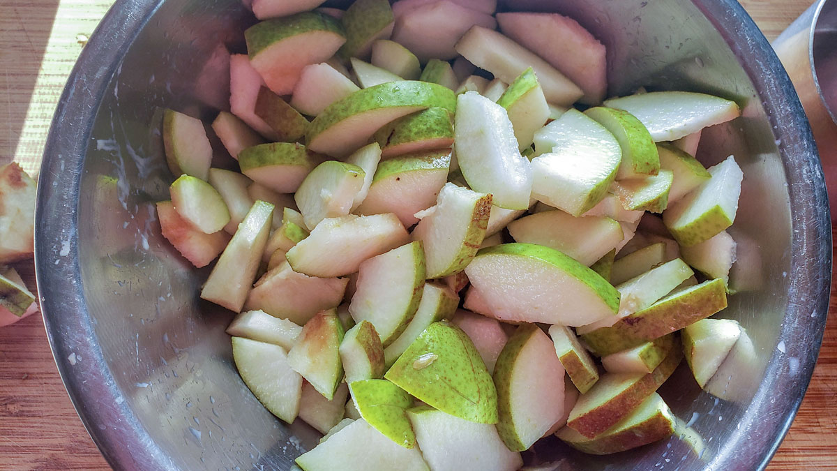 Sliced pears in a metal bowl.