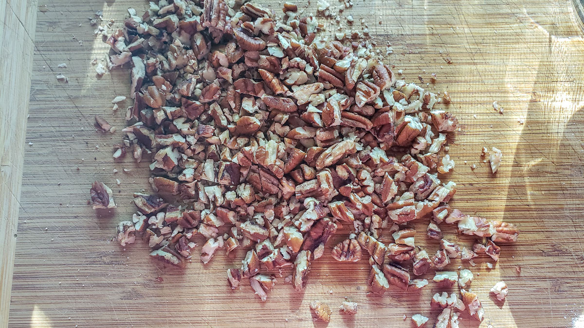 Chopped nuts on a cutting board.