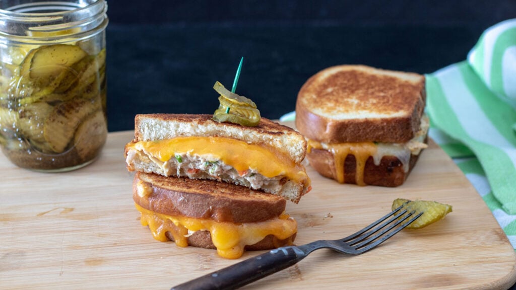 Tuna melt on a wooden cutting board.