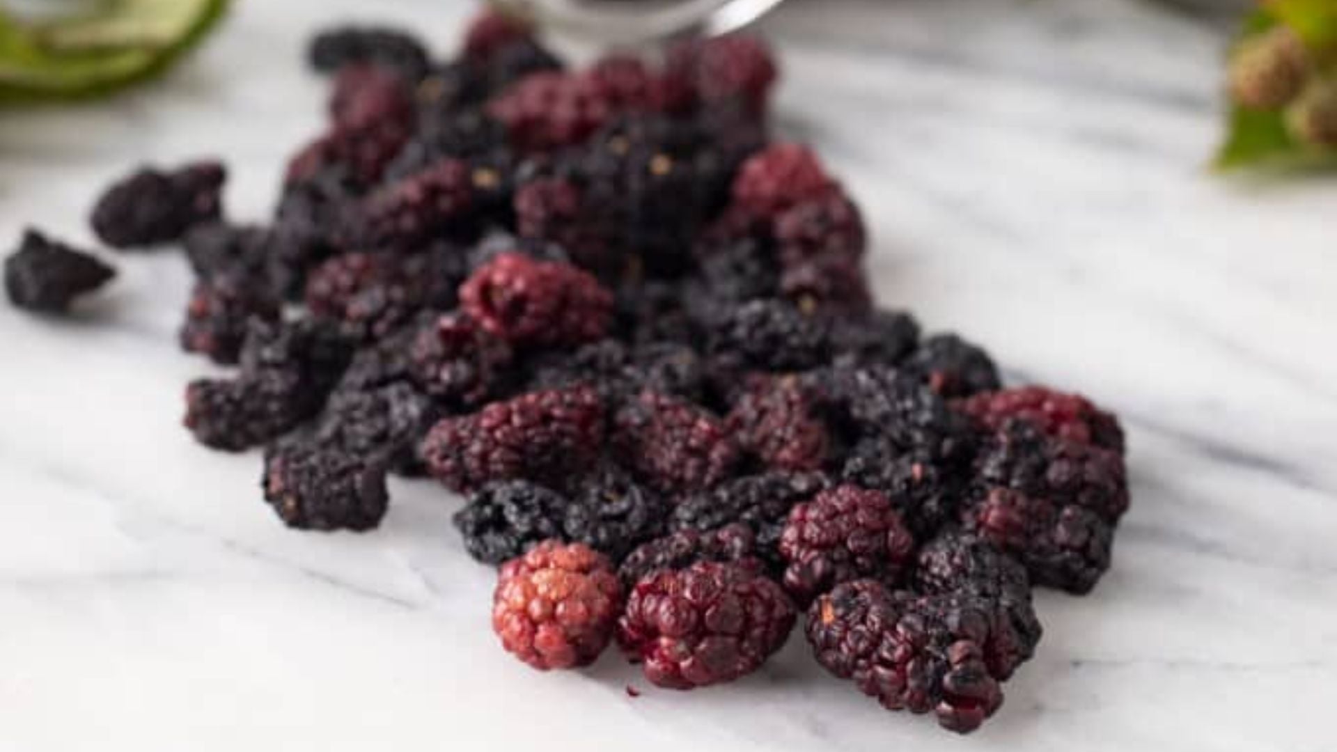 Dried blackberries, whole, spilling out.