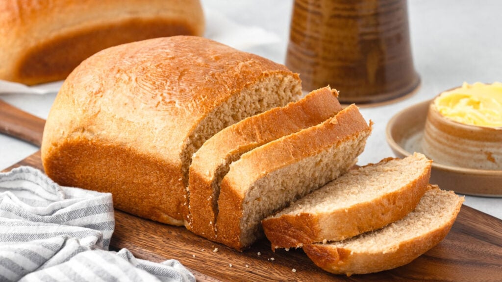 Slice bread on a wooden board.