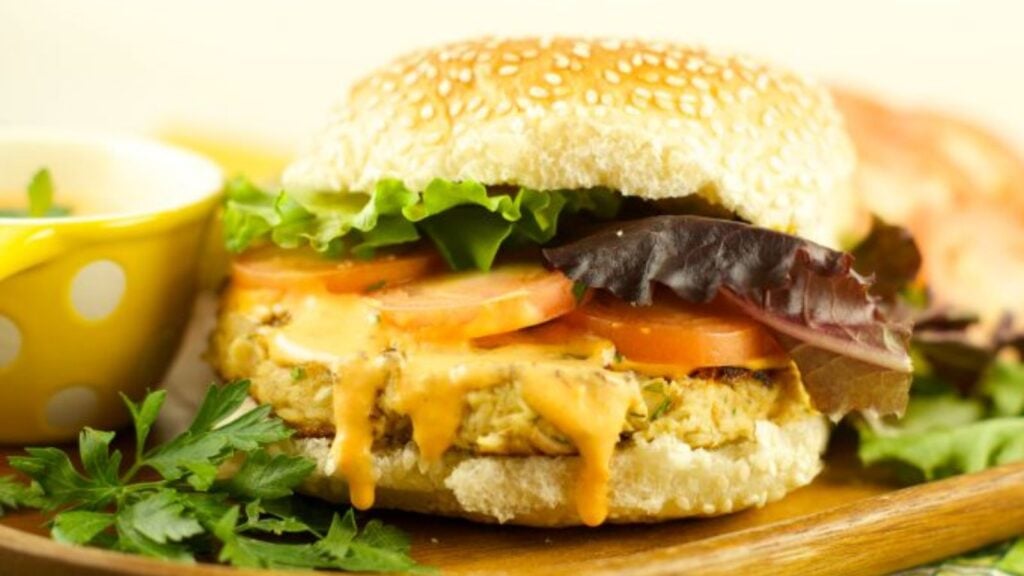 Tuna burgers with roasted pepper tartar sauce on a plate.