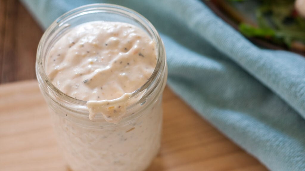 Jar filled with thousand island dressing.