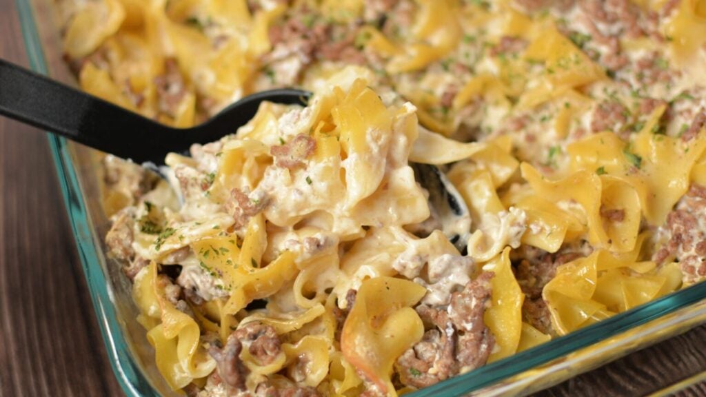 Beef stroganoff casserole on a glass tray.