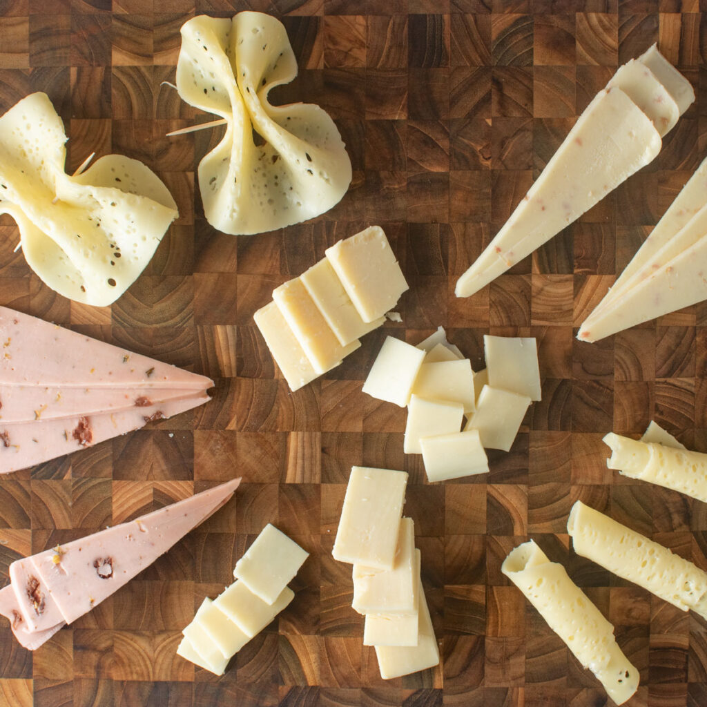 Different shapes and sizes of cut cheese.