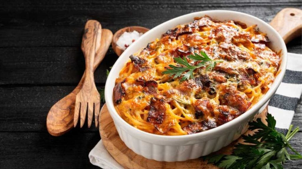 Baked spaghetti on an oval tray.