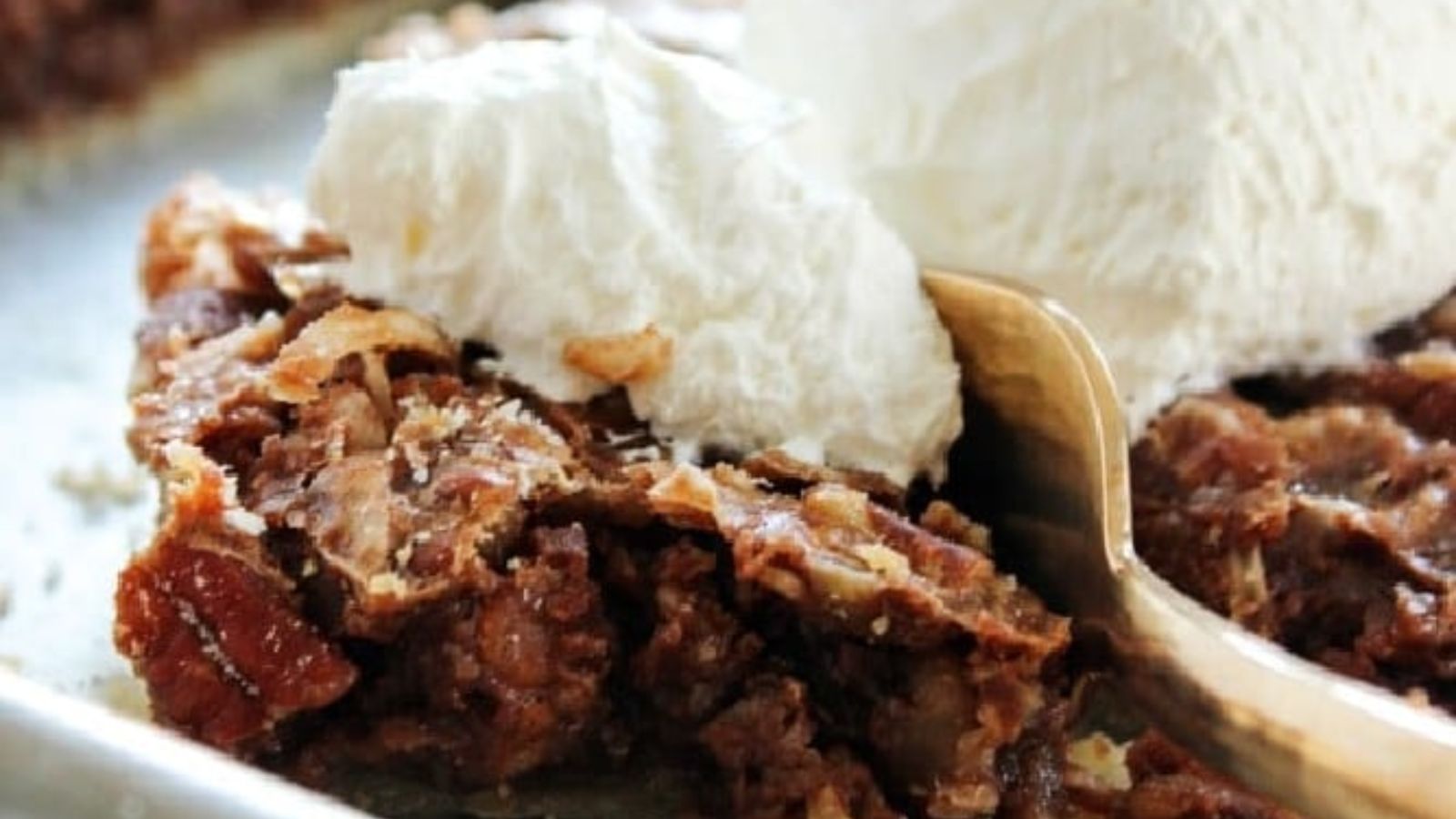 Chocolate slab pie with cream on top.