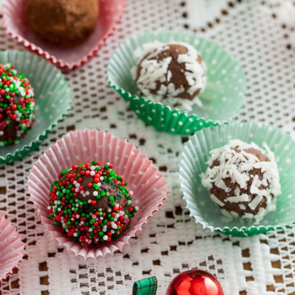 Colorful truffles covered in sprinkles, coconut and cocoa.