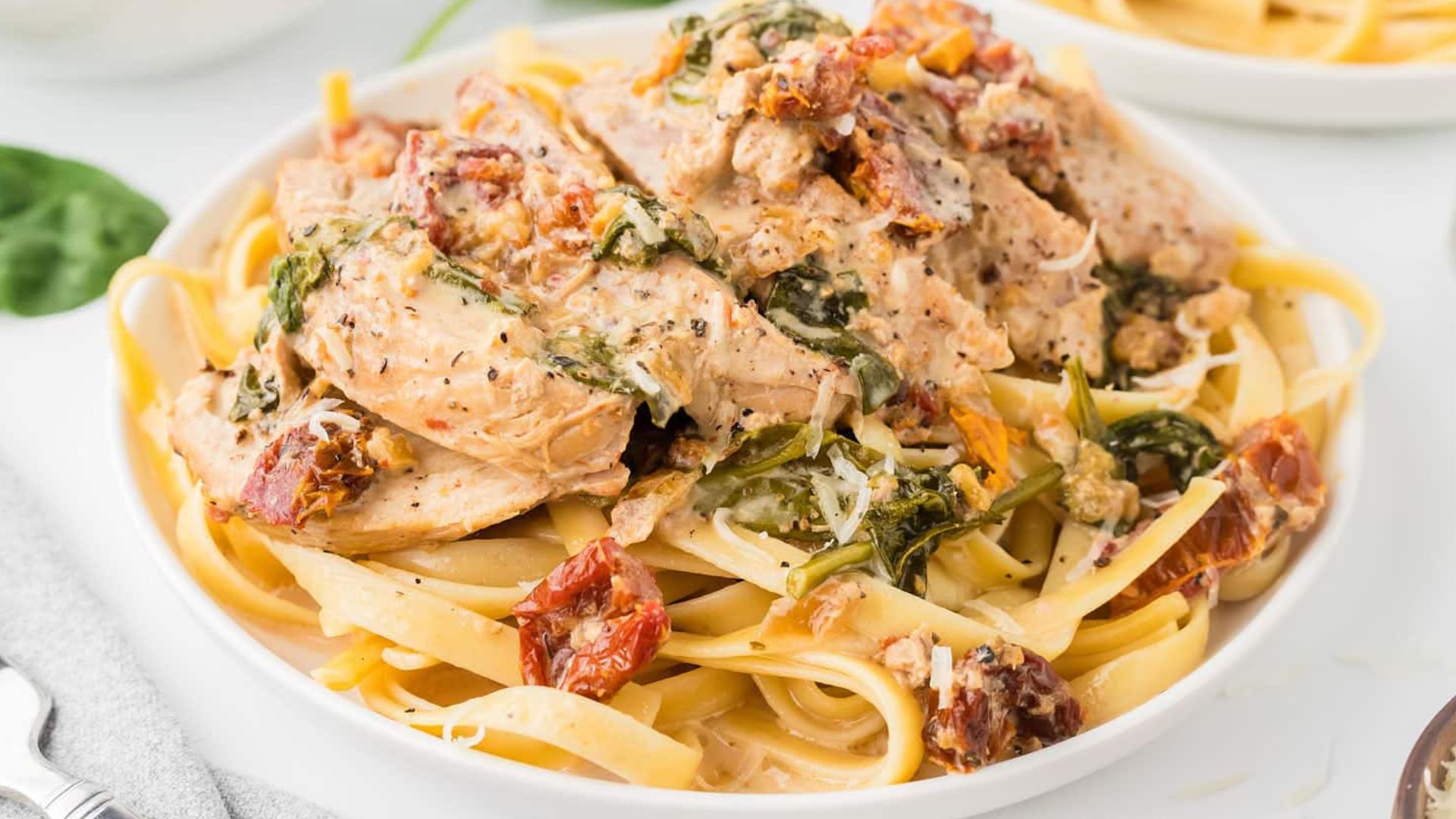 Pasta with sliced chicken on top.