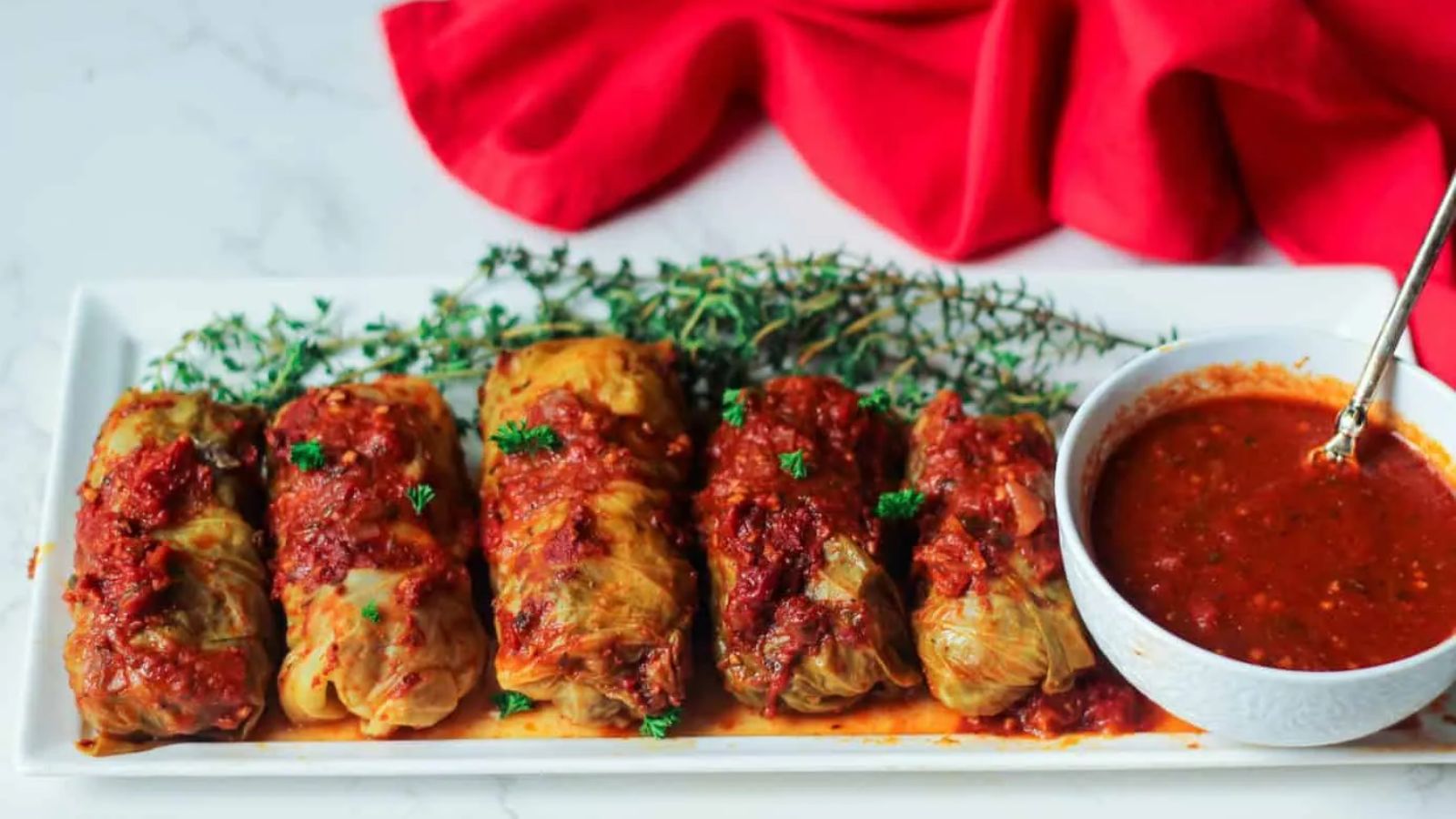 Stuffed cabbage with dip on the side.