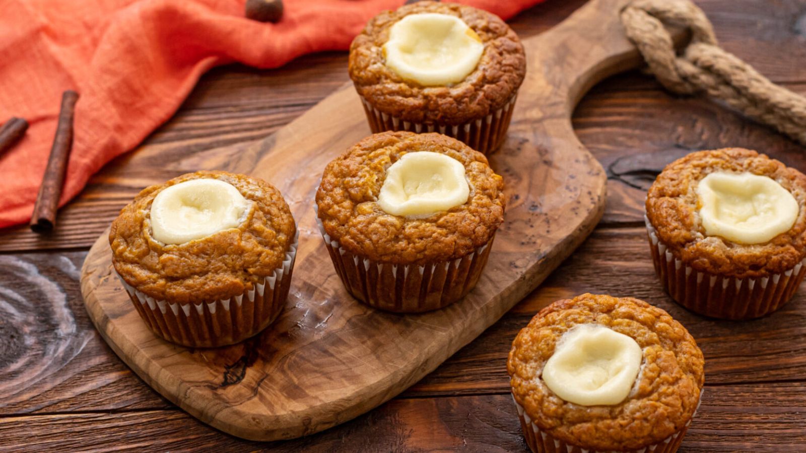 Pumpkin cream muffins on a wooden board.