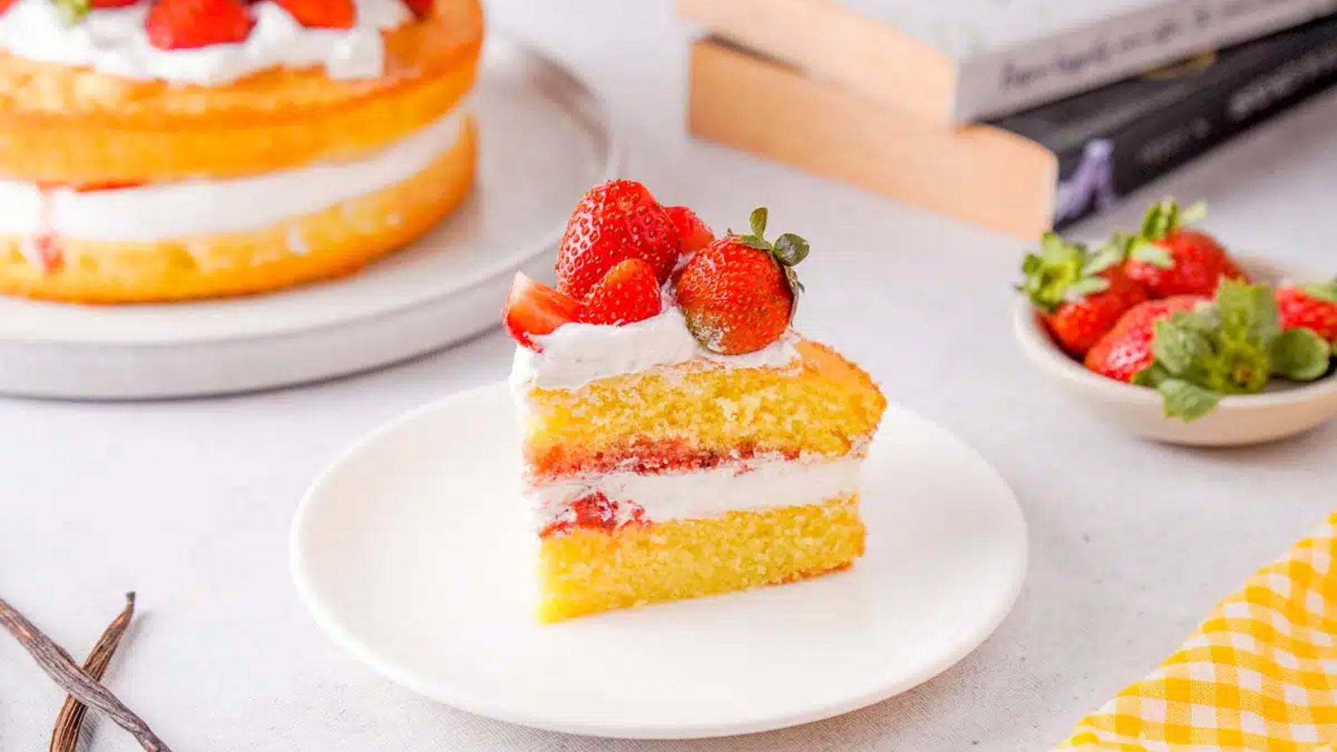 A slice of strawberry cake on a plate.