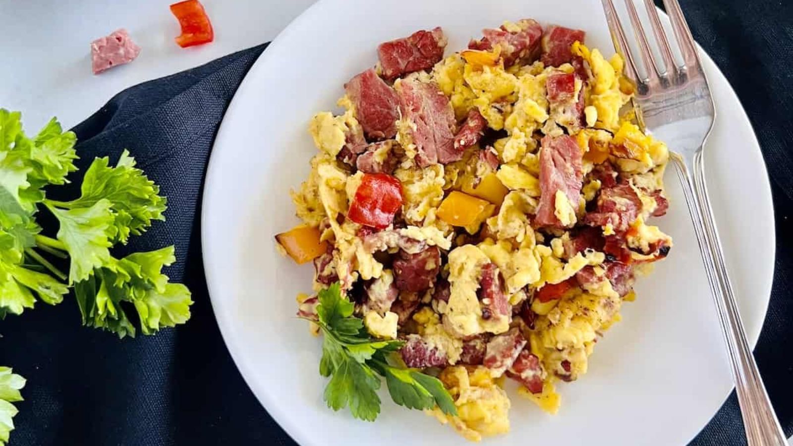 Corned beef and scrambled eggs on a plate.
