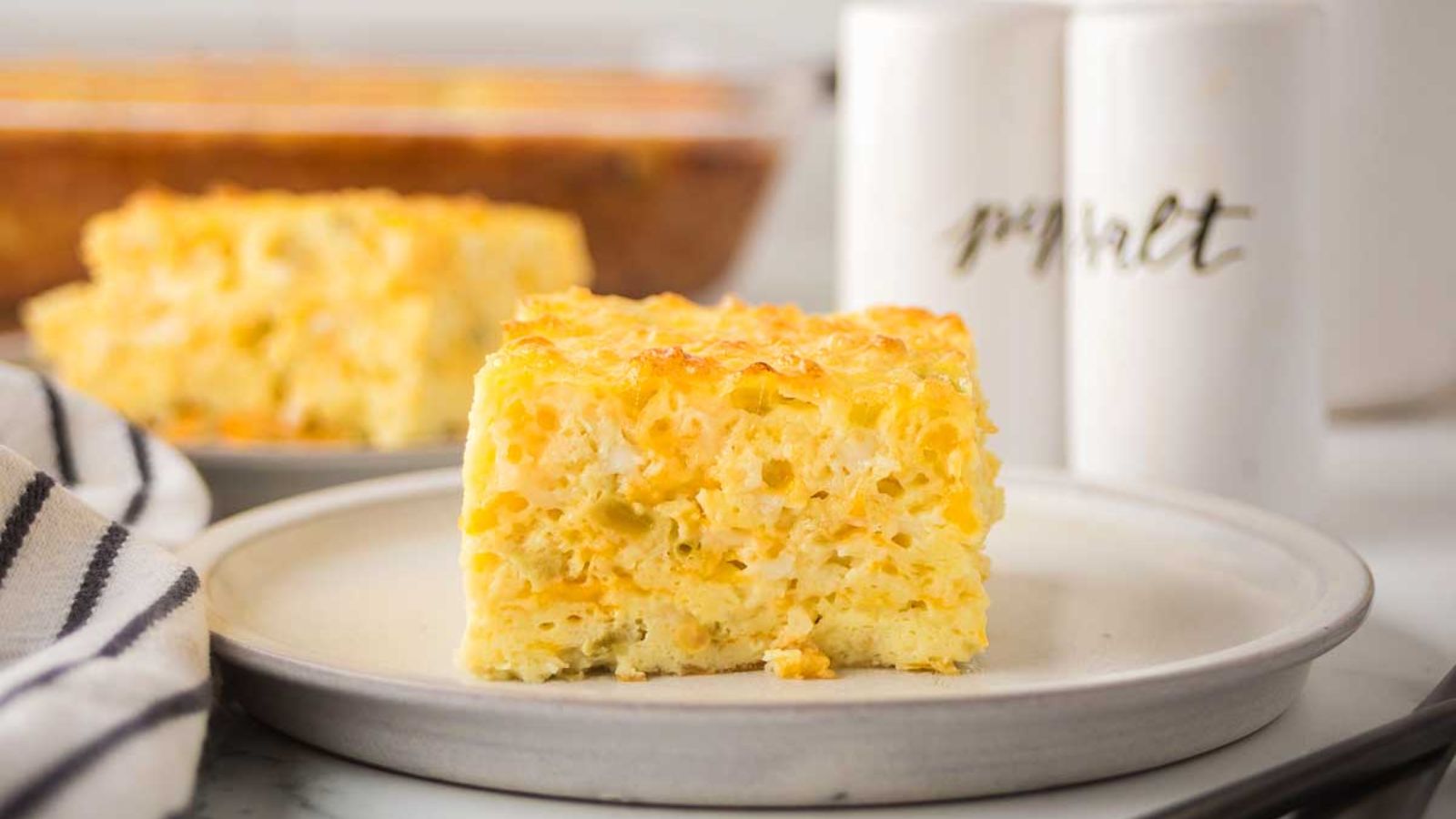 A slice of egg casserole on a plate.