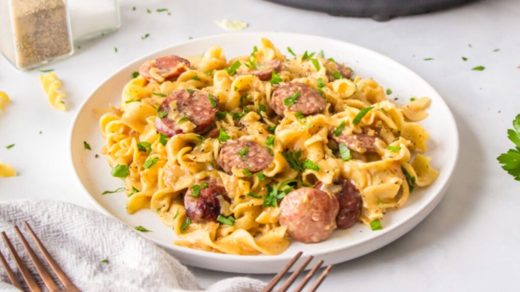 Haluski with kielbasa on a plate.
