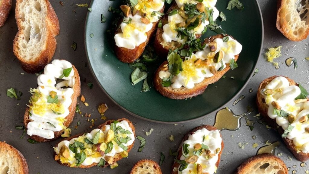 Ricotta crostini on a plate.