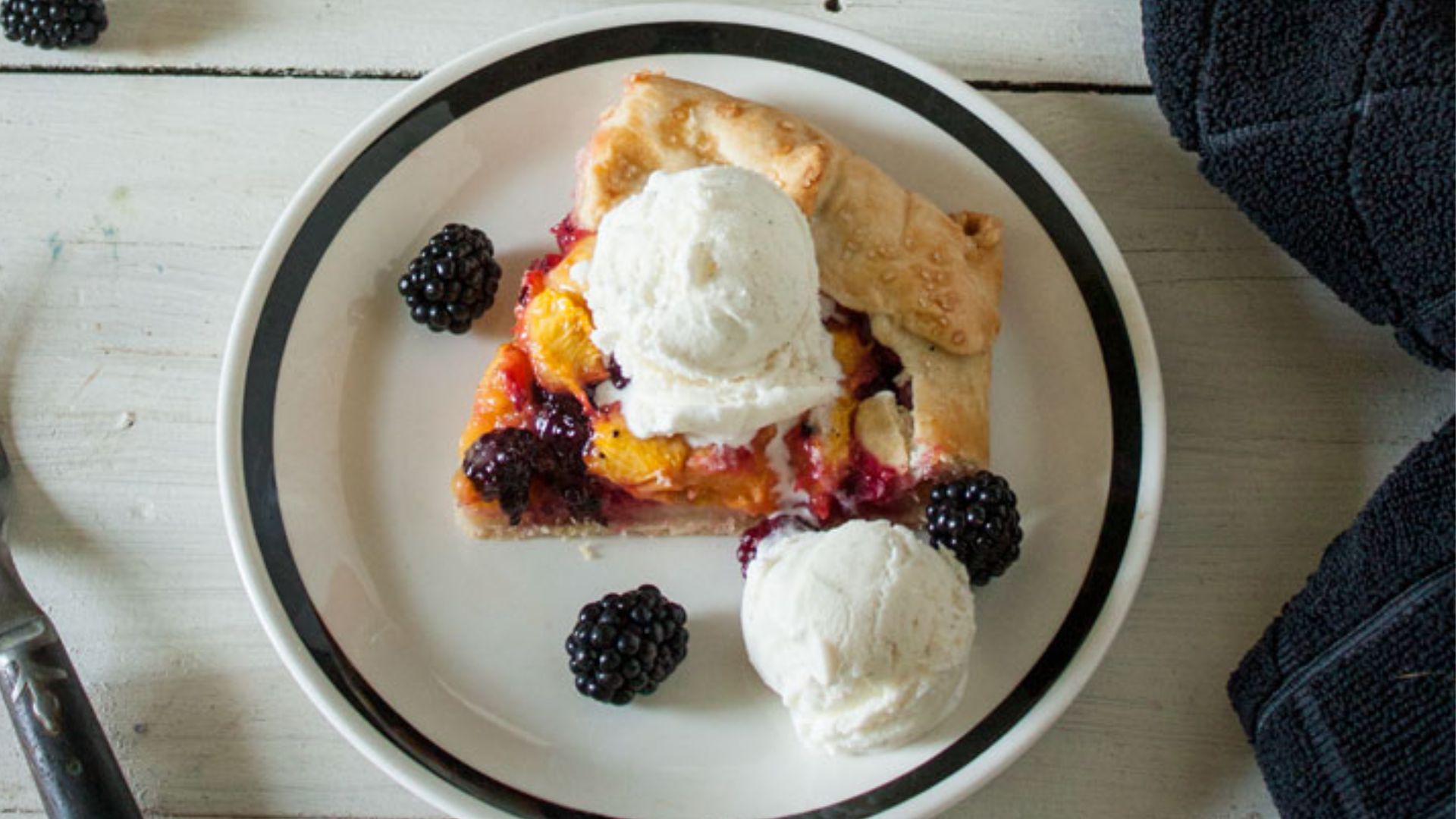 Peach galette with blackberries.