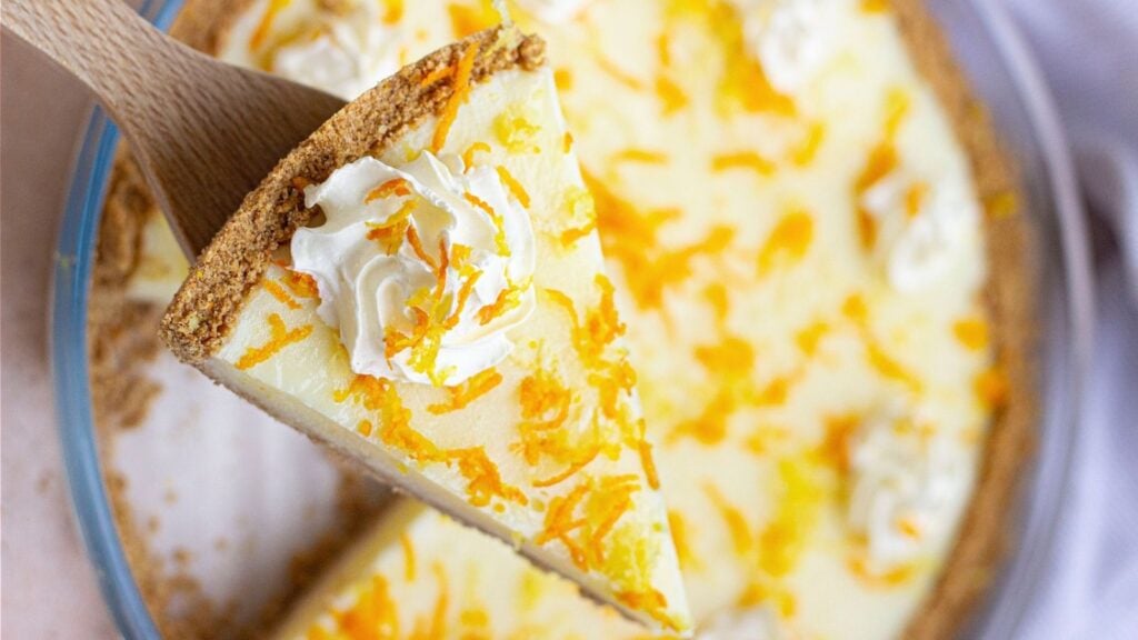 Close up shot of sliced orange lemon pie.