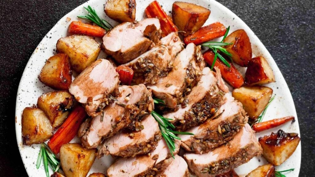 Tenderloin pork with potatoes on a plate.