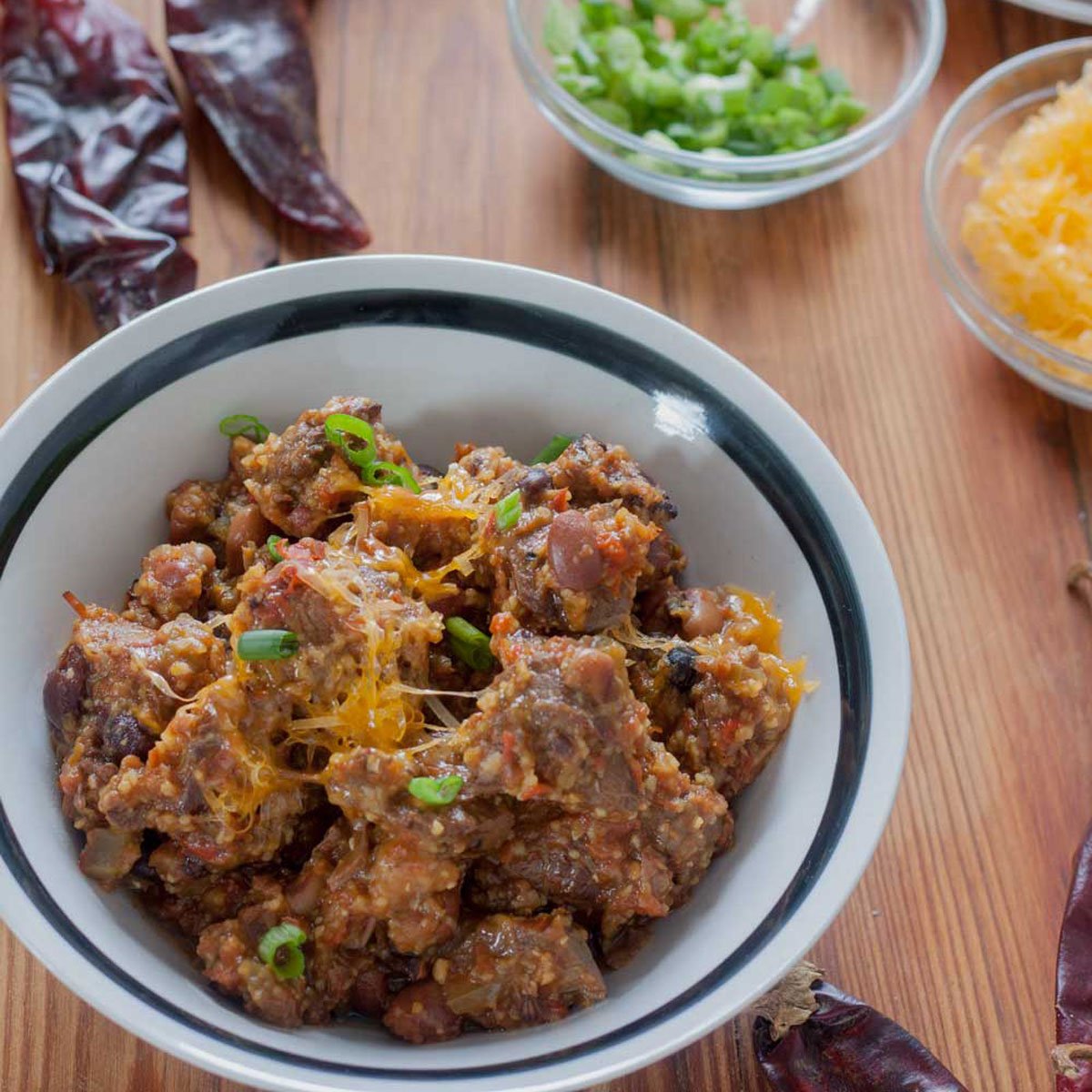Venison chili in a white bowl with a black rim.