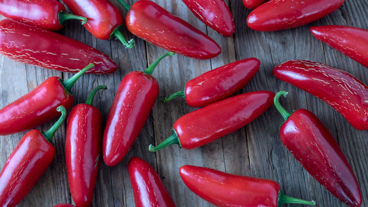 Red chipotles on barnwood.