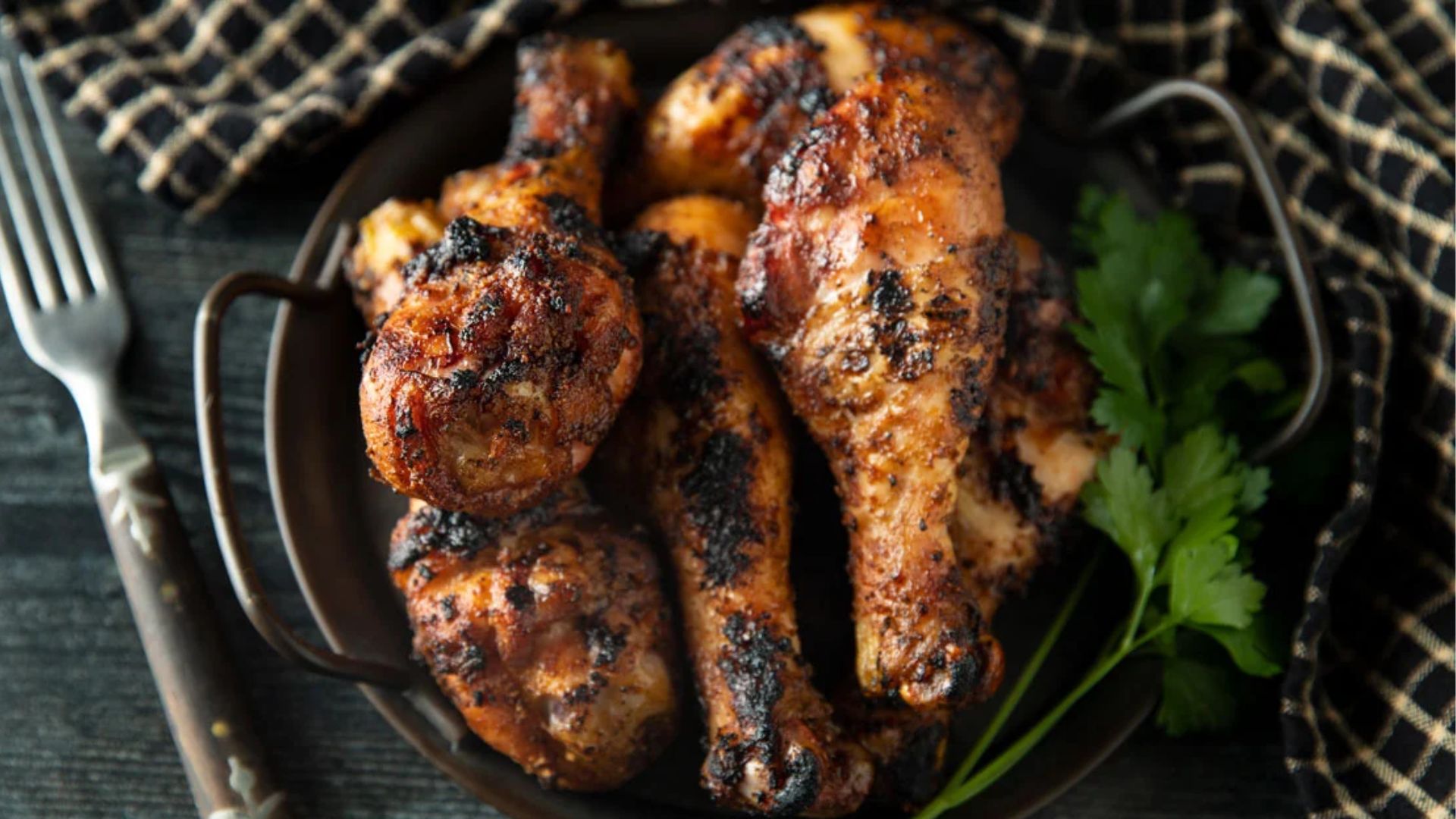 Smoked chicken legs in a pewter tray.
