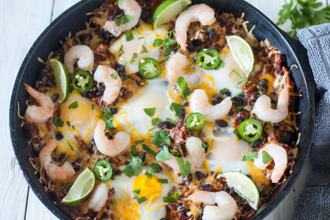 Chilaquiles with shrimp in a cast iron skillet.