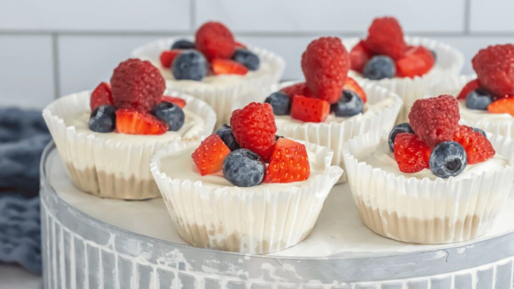 Mini mixed berry cheesecakes topped with fresh berries