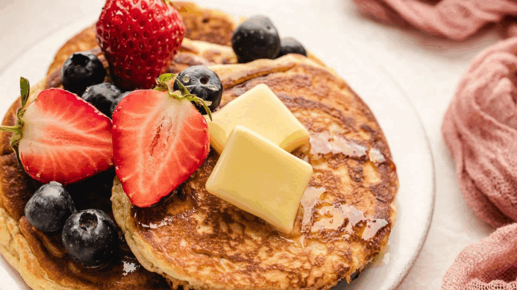 Sweet Cream Pancakes with berries and butter on top