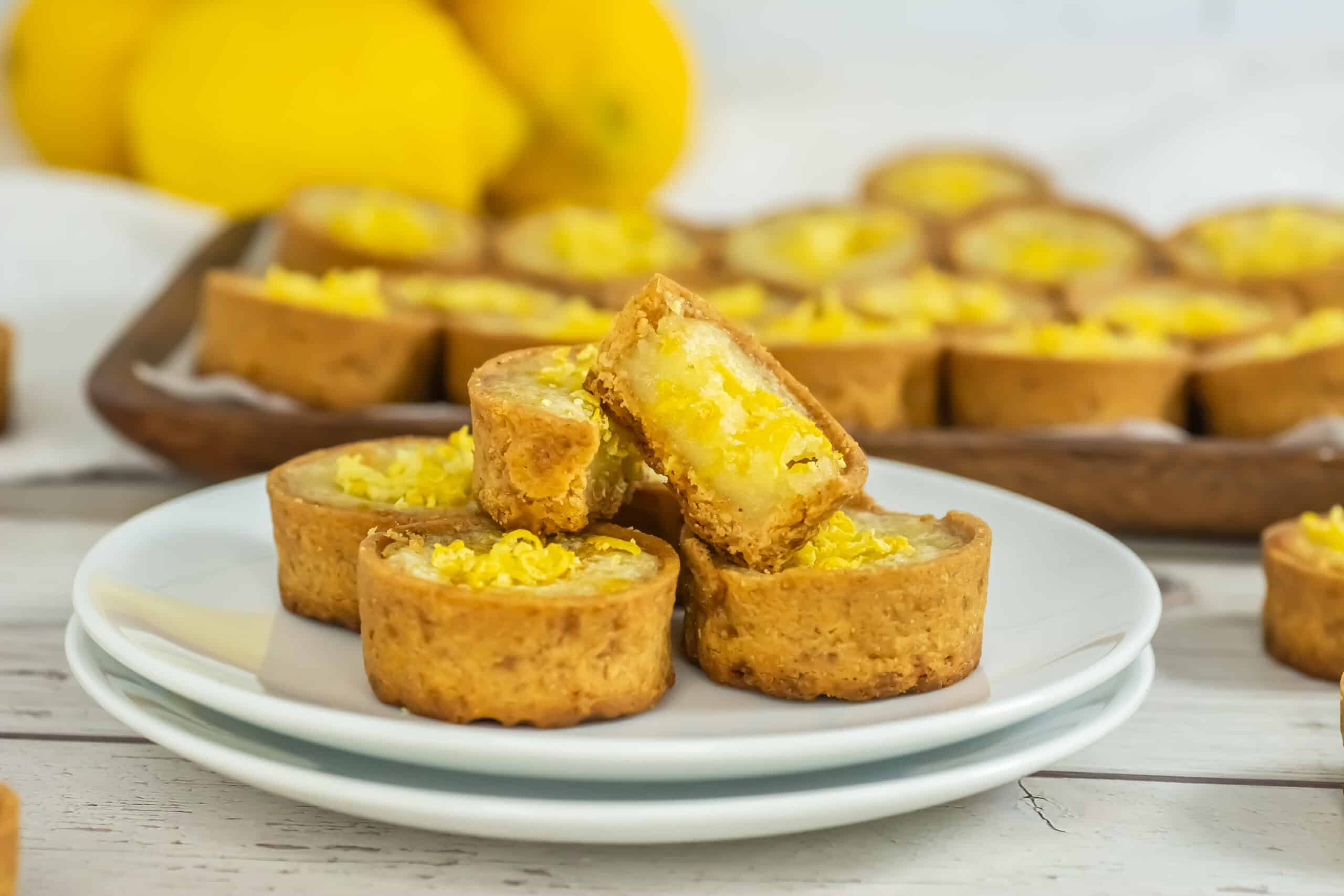 A plate filled with Mini Lemon Tarts