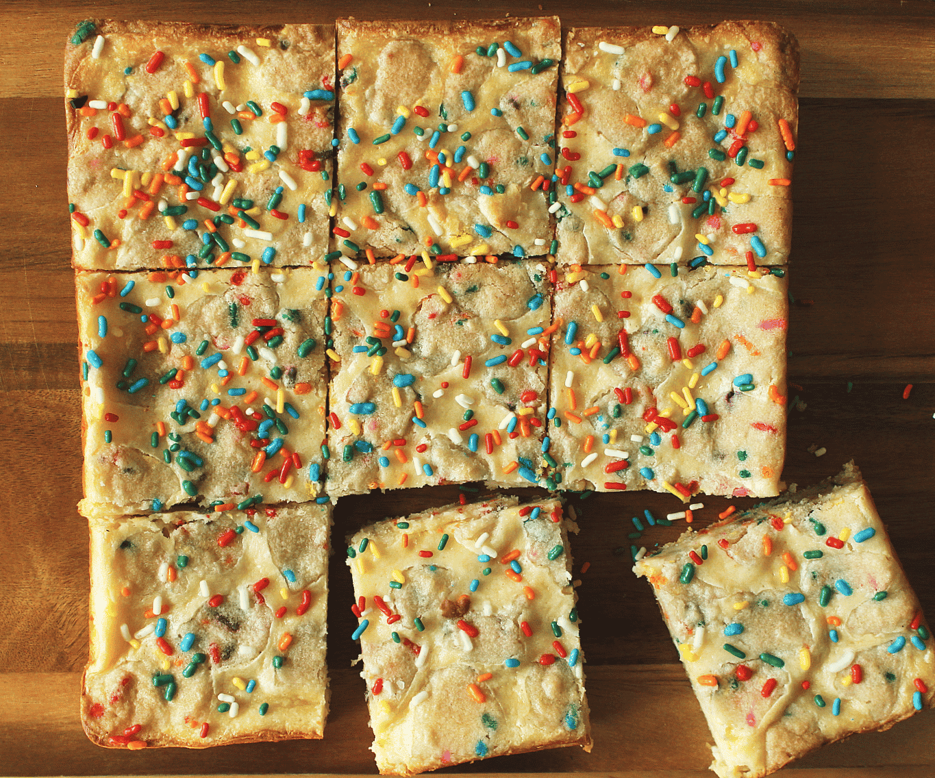 An overhead shot of sliced Funfetti Sugar Cookie Cheesecake Bars