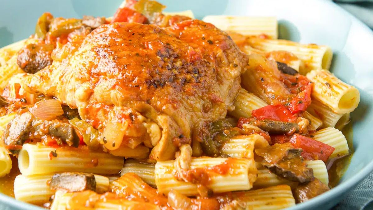 Chicken breast atop pile of pasta.