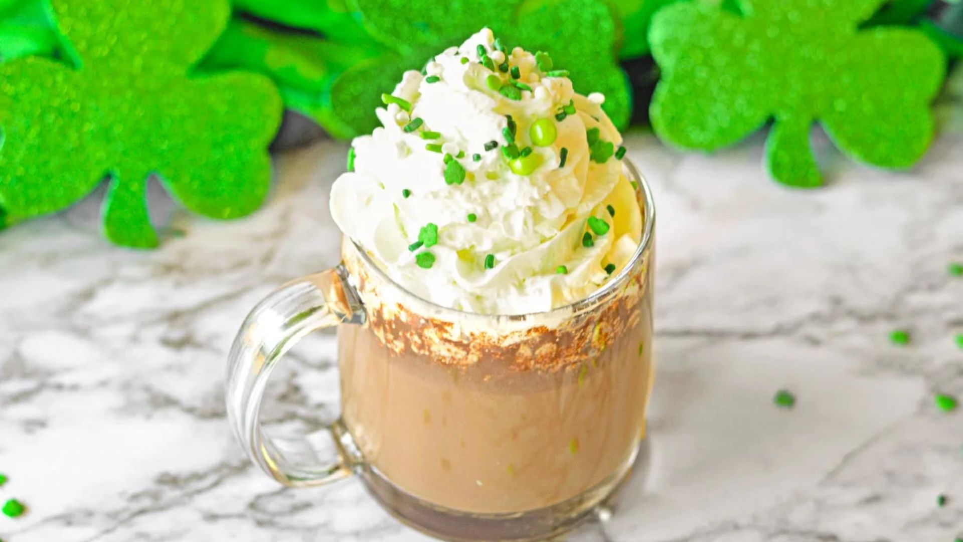 A close up shot of hot chocolate with green sprinkles.