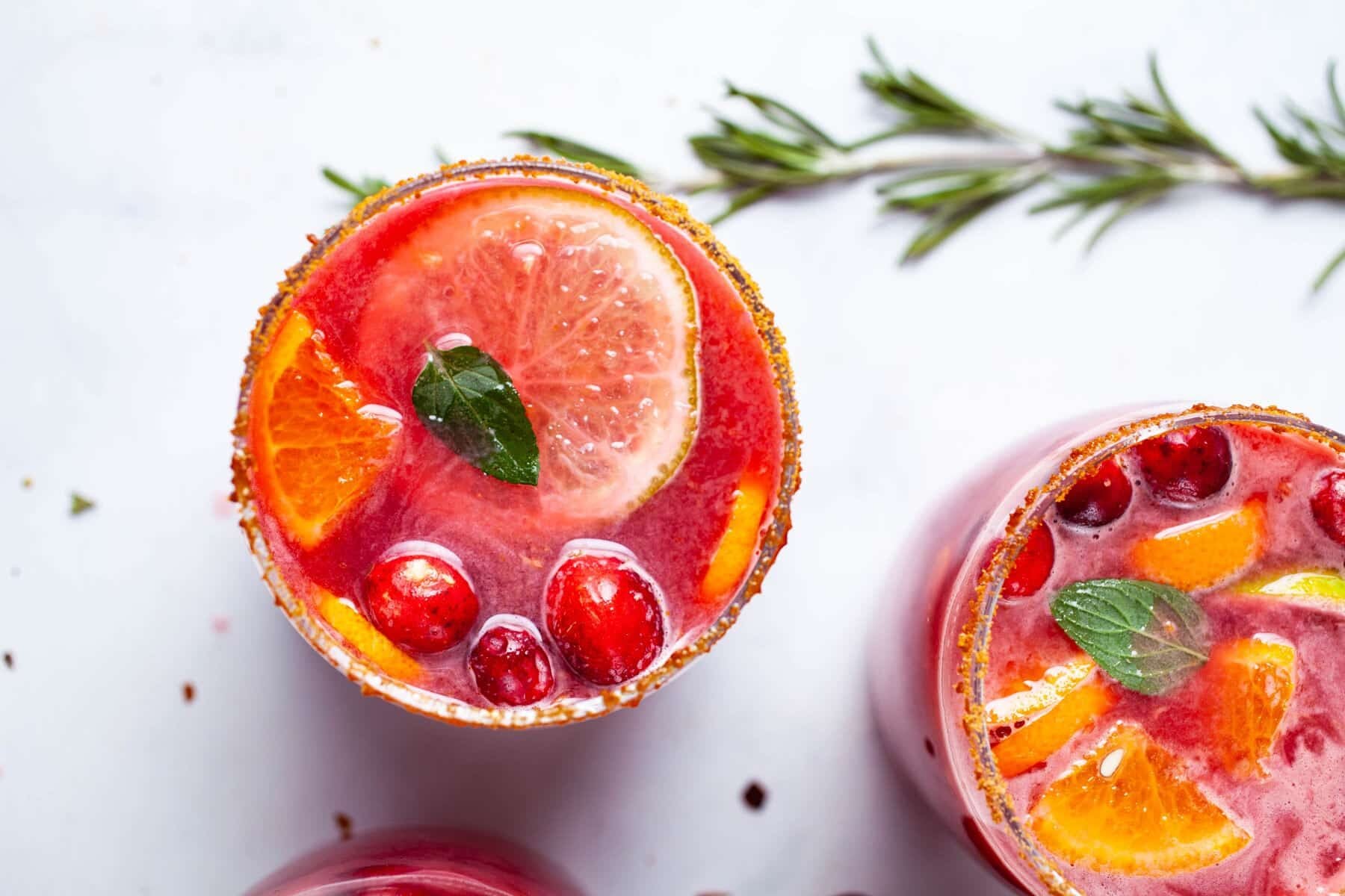 An overhead shot of two Festive pomegranate Mocktails great for New Years