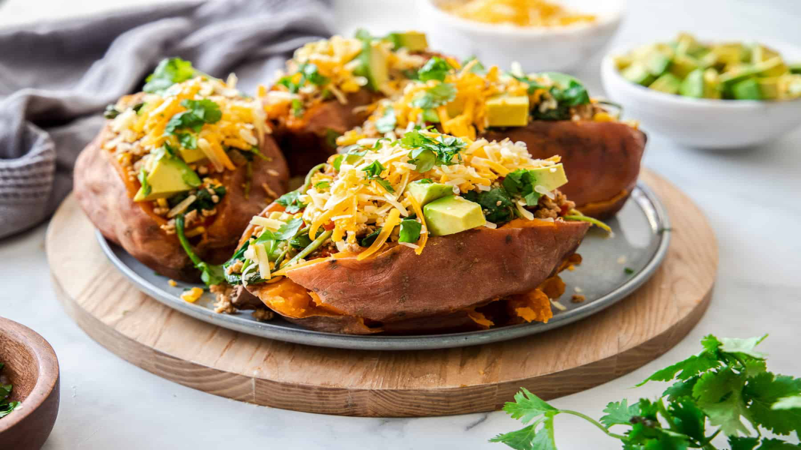 A plate with four Taco-Stuffed Sweet Potatoes.