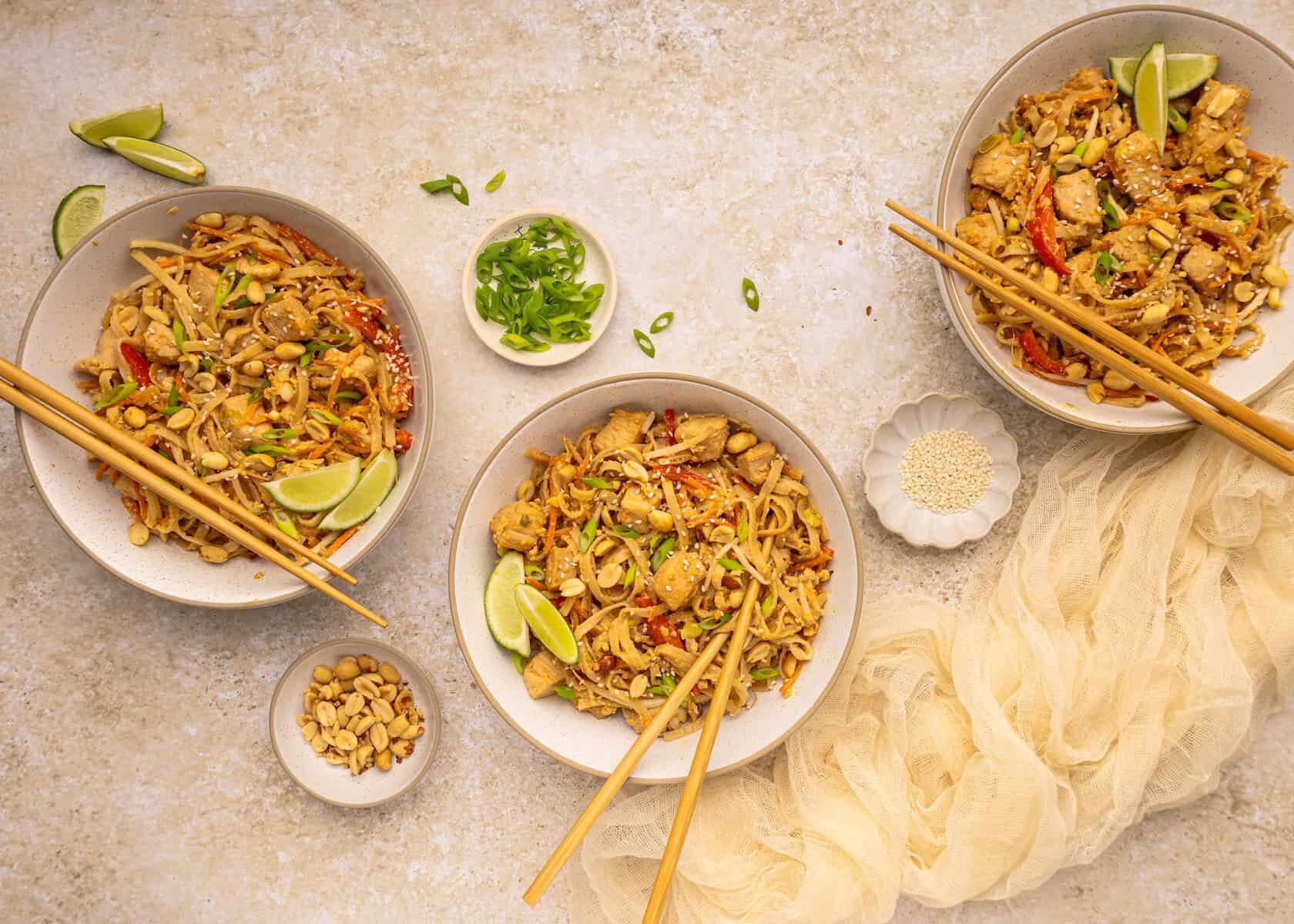 Three plates of Chicken Pad Thai.