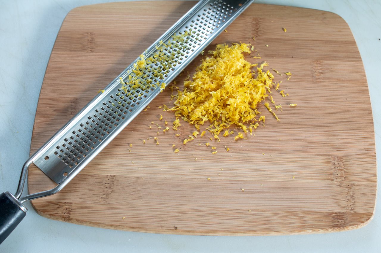 Grate the lemon zest.