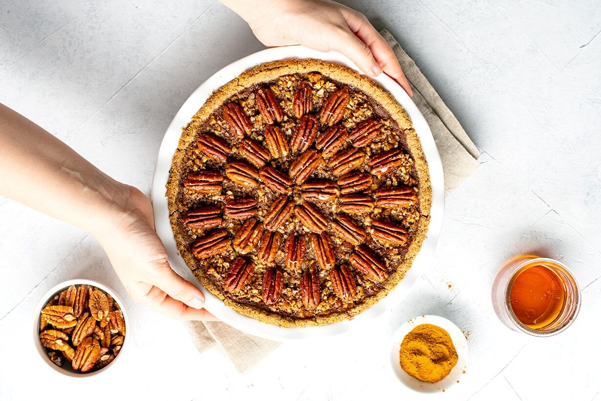 A whole Pumpkin Pie with a Pecan Crust and Topping.