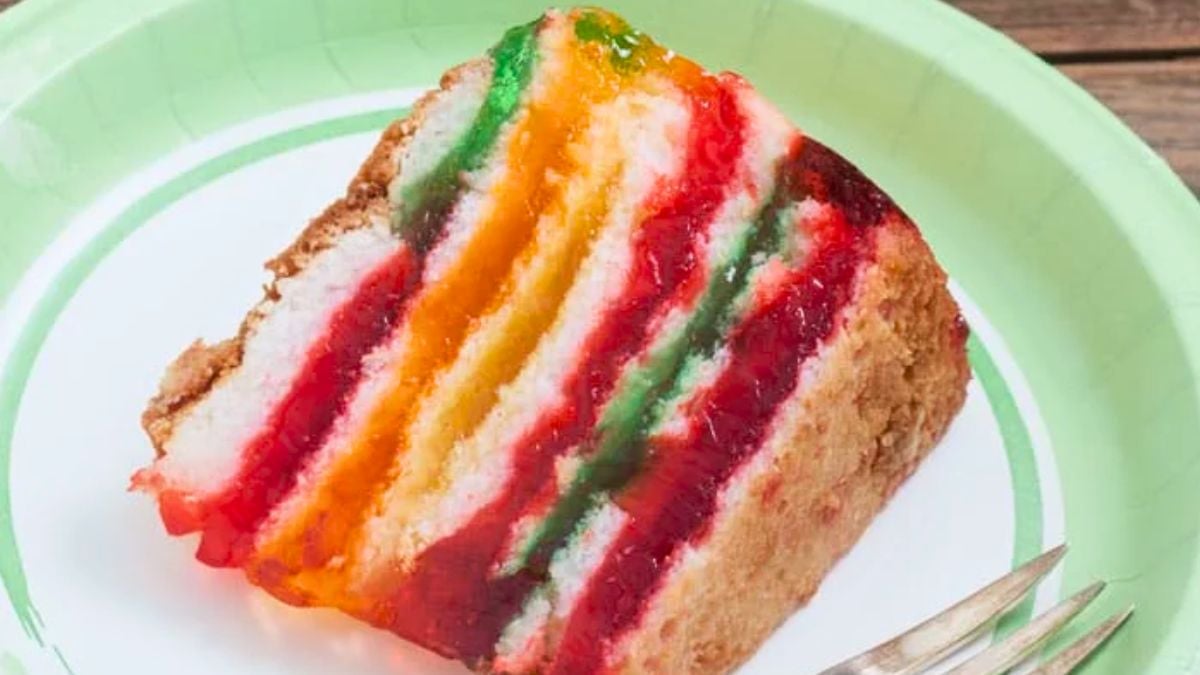 Slice of colorful rainbow jello cake.
