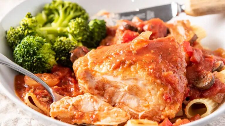 A forkful of chicken in a plate with the thigh and broccoli next to it