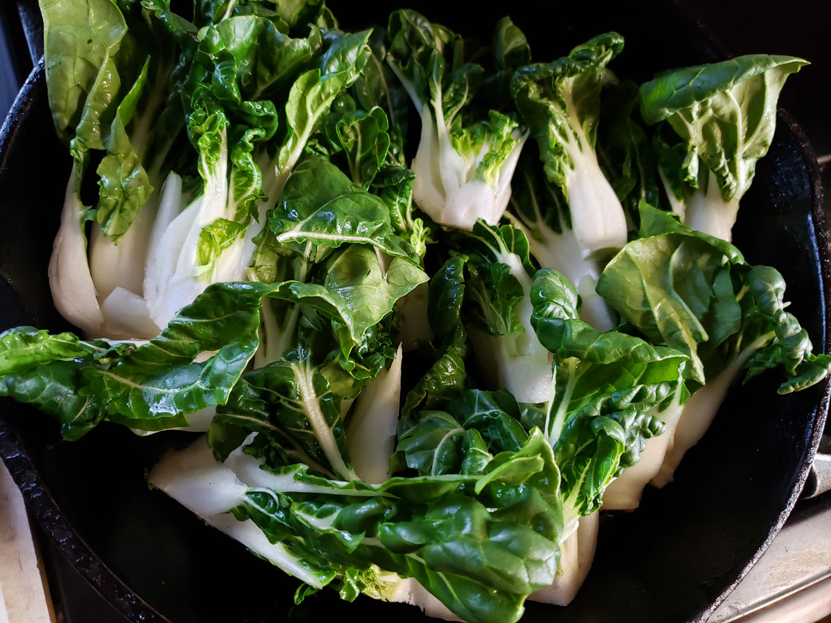 Sautéing bok choy in cast iron skillet.