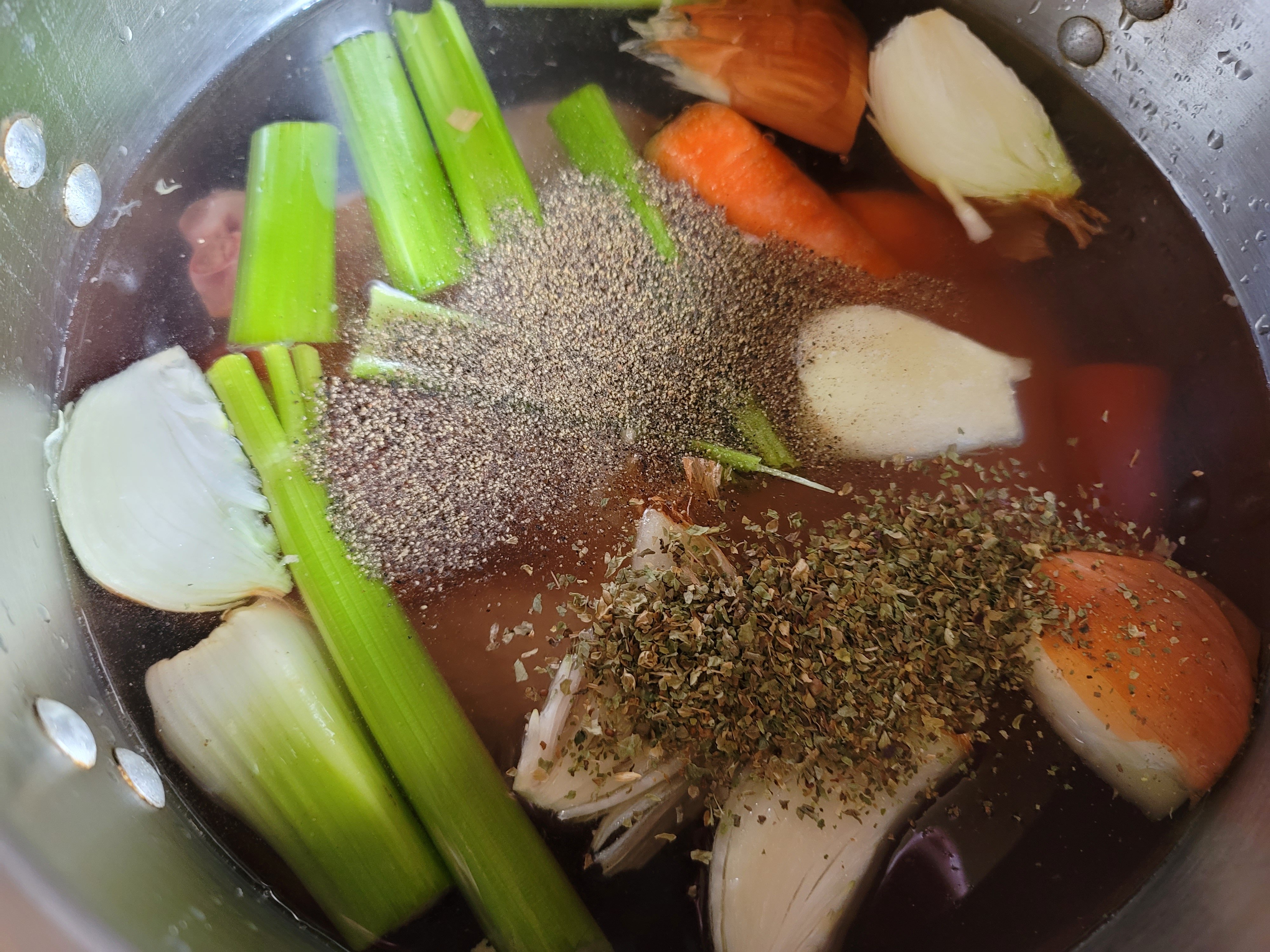 Salt, pepper and spices added to the pot.