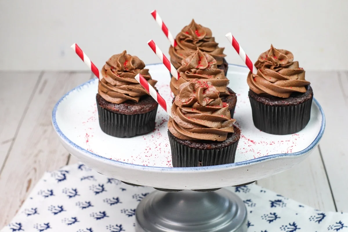 Four Dr. Pepper Cupcakes on a cupcake stand.